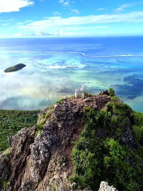 Rocky mountain peak overlooking a tropical bay and ocean
