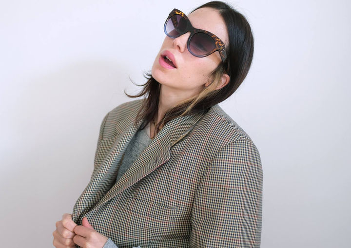 DressYourMind Eyewear blue cat eye framed retro sunglasses on an elegant female fashion model with blonde hairs, premium vintage-inspired eyewear with UV400 lenses