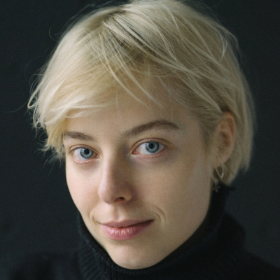 Woman with short blonde hair and blue eyes