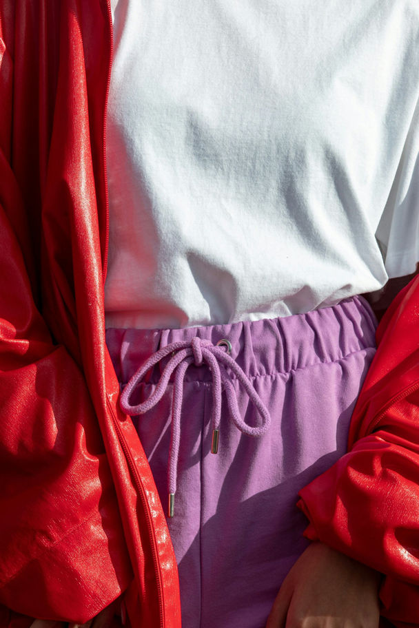 White t-shirt, purple drawstring pants, red jacket