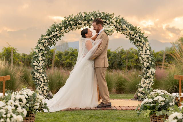 Wedding couple under floral arch