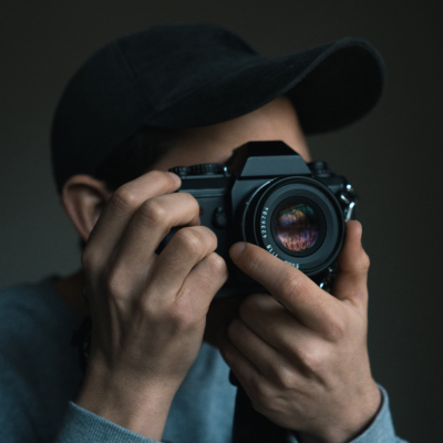 Person holding camera to face