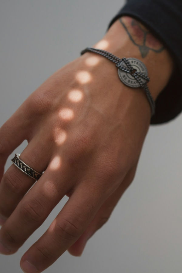 Hand wearing a bold cuff bracelet and ring
