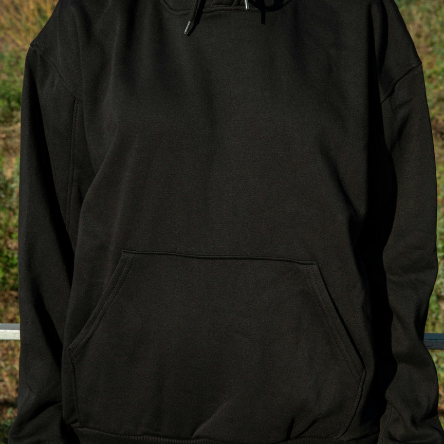 Person wearing black hoodie with hood up