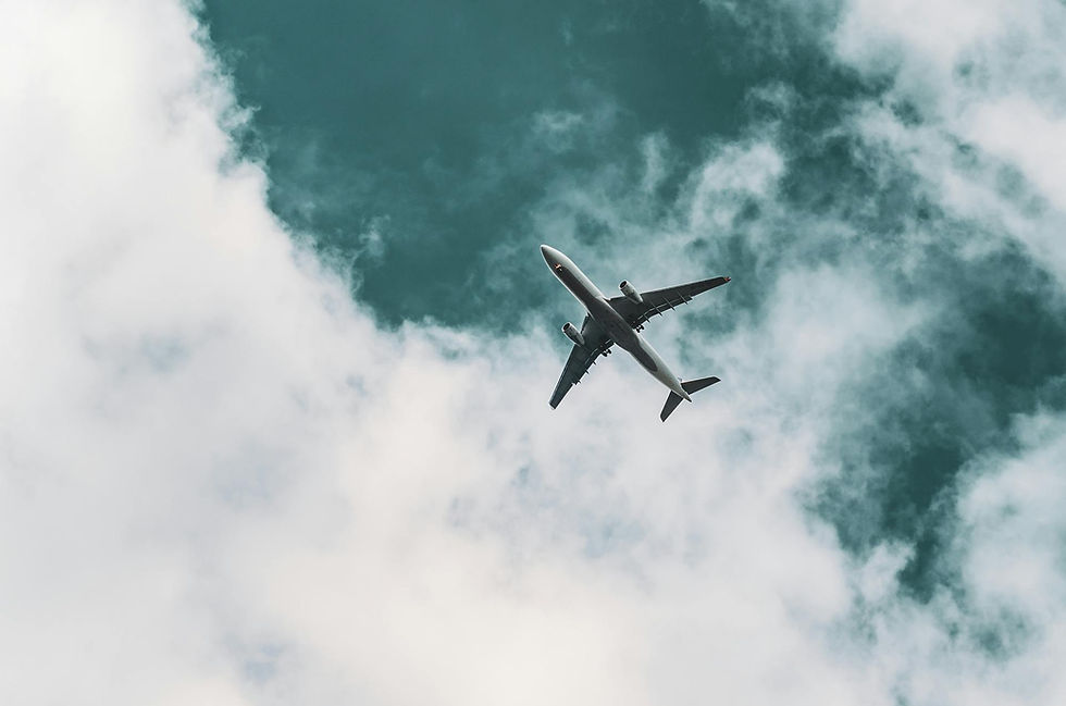Airplane flying in a cloudy sky