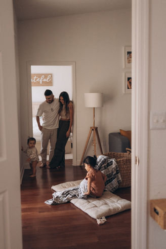 Parents and young children gathered together at home during a candid everyday moment