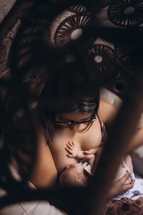 Mother breastfeeding her newborn baby during a quiet moment at home