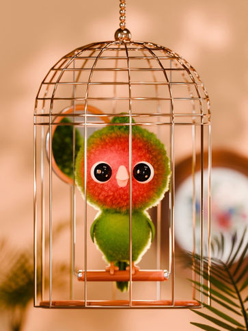 Small colorful character inside a golden birdcage with soft lighting and shallow depth of field.