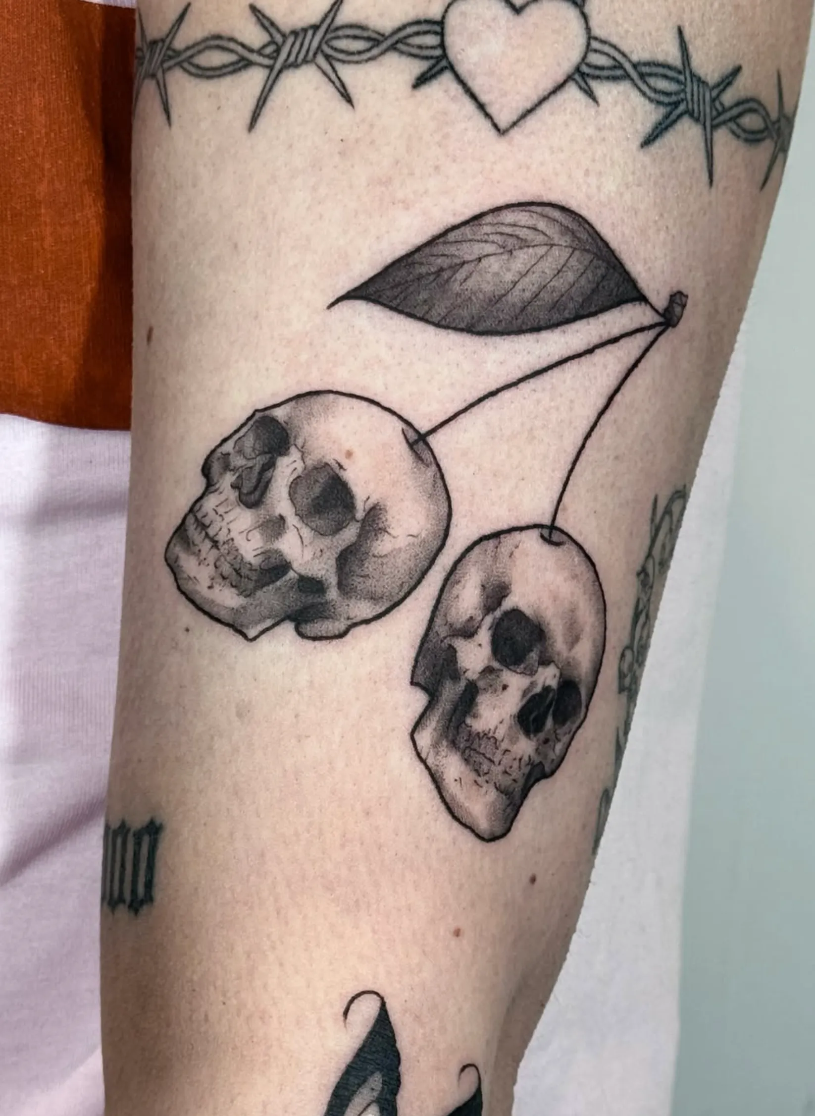 Blackwork skull cherries forearm tattoo by Chorley at The Story of Us MCR, Castlefield Manchester