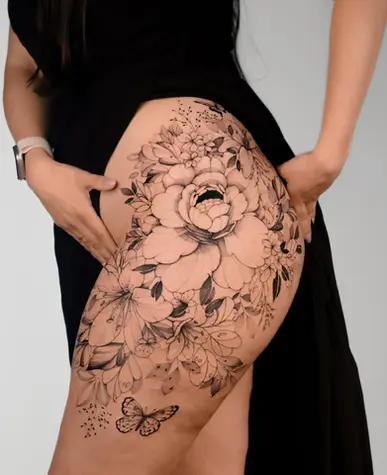 Fine line large scale botanical hip and thigh tattoo by Nicolly at The Story of Us MCR, near Deansgate Manchester