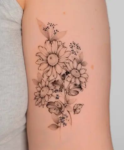 Fine line black and grey daisy bouquet upper arm tattoo by Nicolly at The Story of Us MCR, near Deansgate Manchester