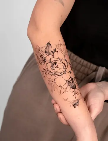 Fine line peony bee and script forearm tattoo by Nicolly at The Story of Us MCR, near Deansgate Manchester
