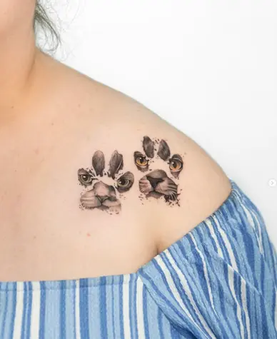 Fine line dual cat face paw print collarbone tattoo by Nicolly at The Story of Us MCR, Castlefield Manchester
