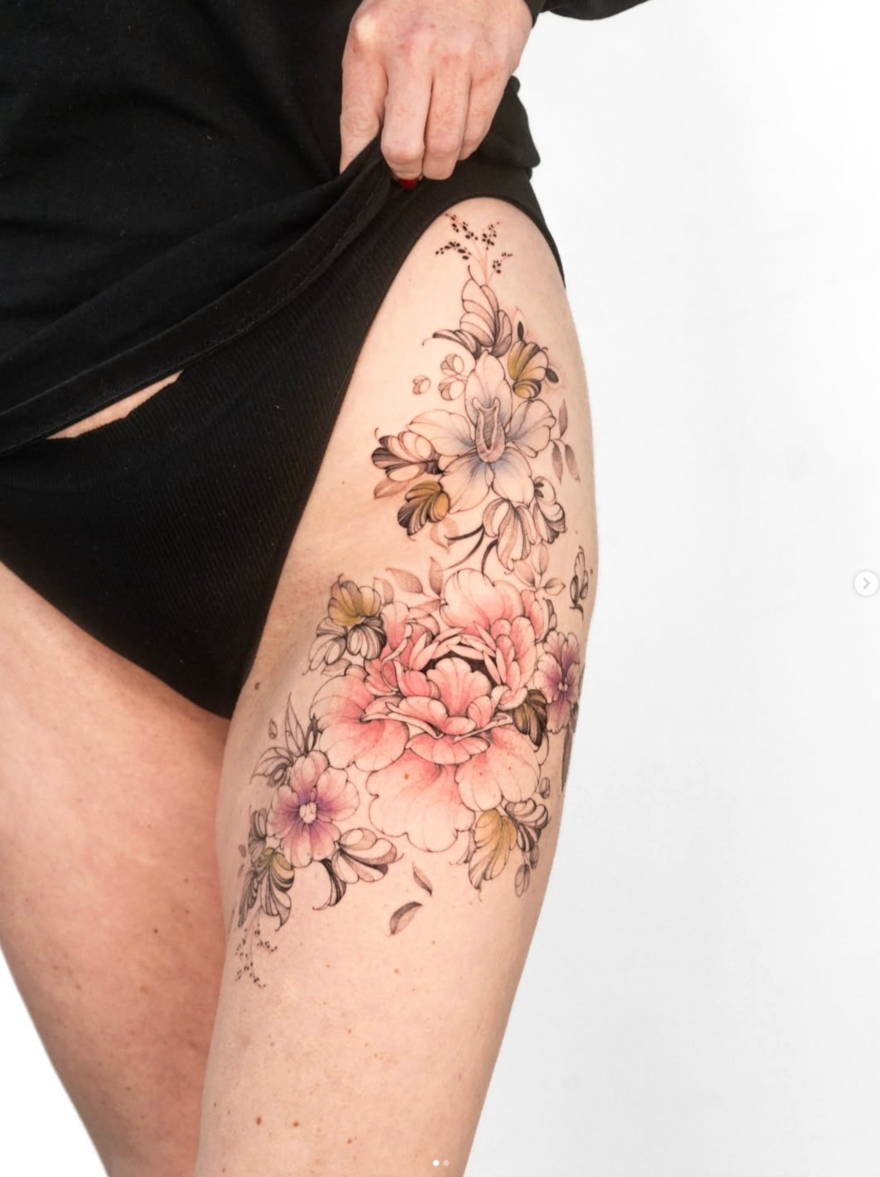 Colour fine line botanical floral thigh tattoo by Nicolly at The Story of Us MCR, near Deansgate Manchester