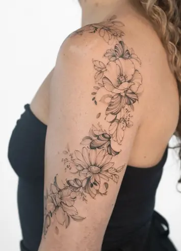 Fine line botanical floral shoulder arm sleeve tattoo by Nicolly at The Story of Us MCR, Castlefield Manchester