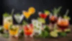 Eye-level view of an assortment of classic cocktails garnished with fresh herbs