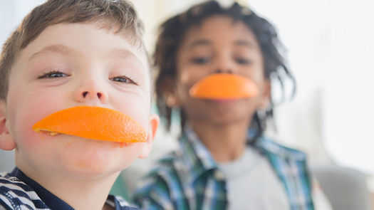 image is of Children eating orange peels