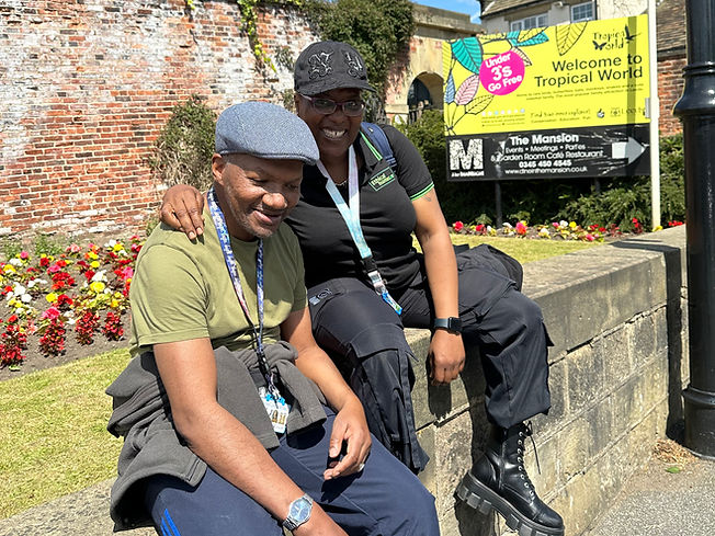 man and woman.both outside.both sitting. both wearing hat.both smiling.tropical world Leeds.