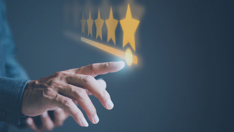 A hand selecting five stars