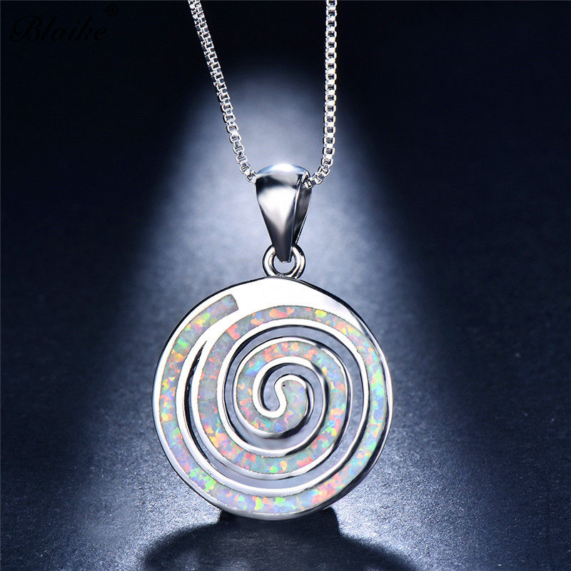 Thumbnail: Spiral silver pendant inlaid with an opal gemstone