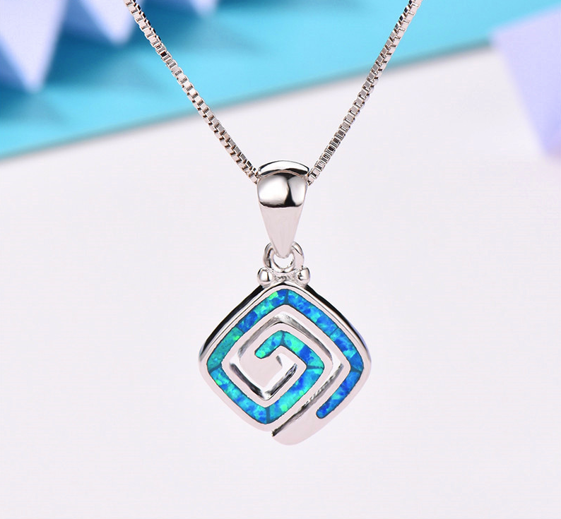 Thumbnail: Square spiral silver pendant studded with a blue opal gemstone