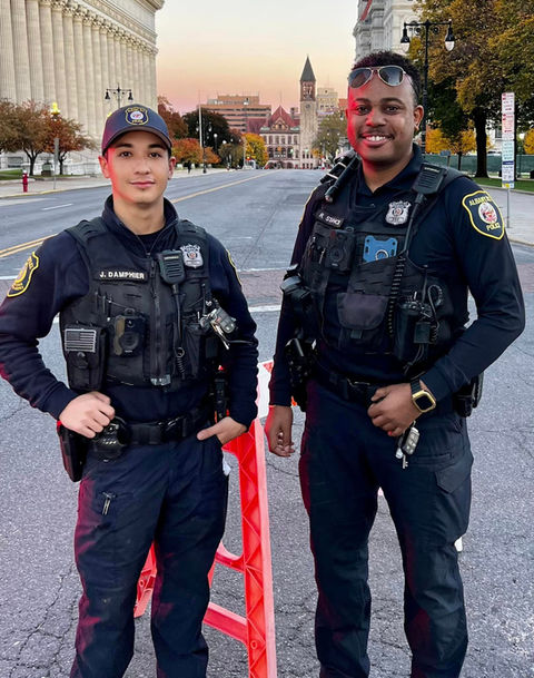 Officer Duo standing in front of city hall at sunset.jpeg