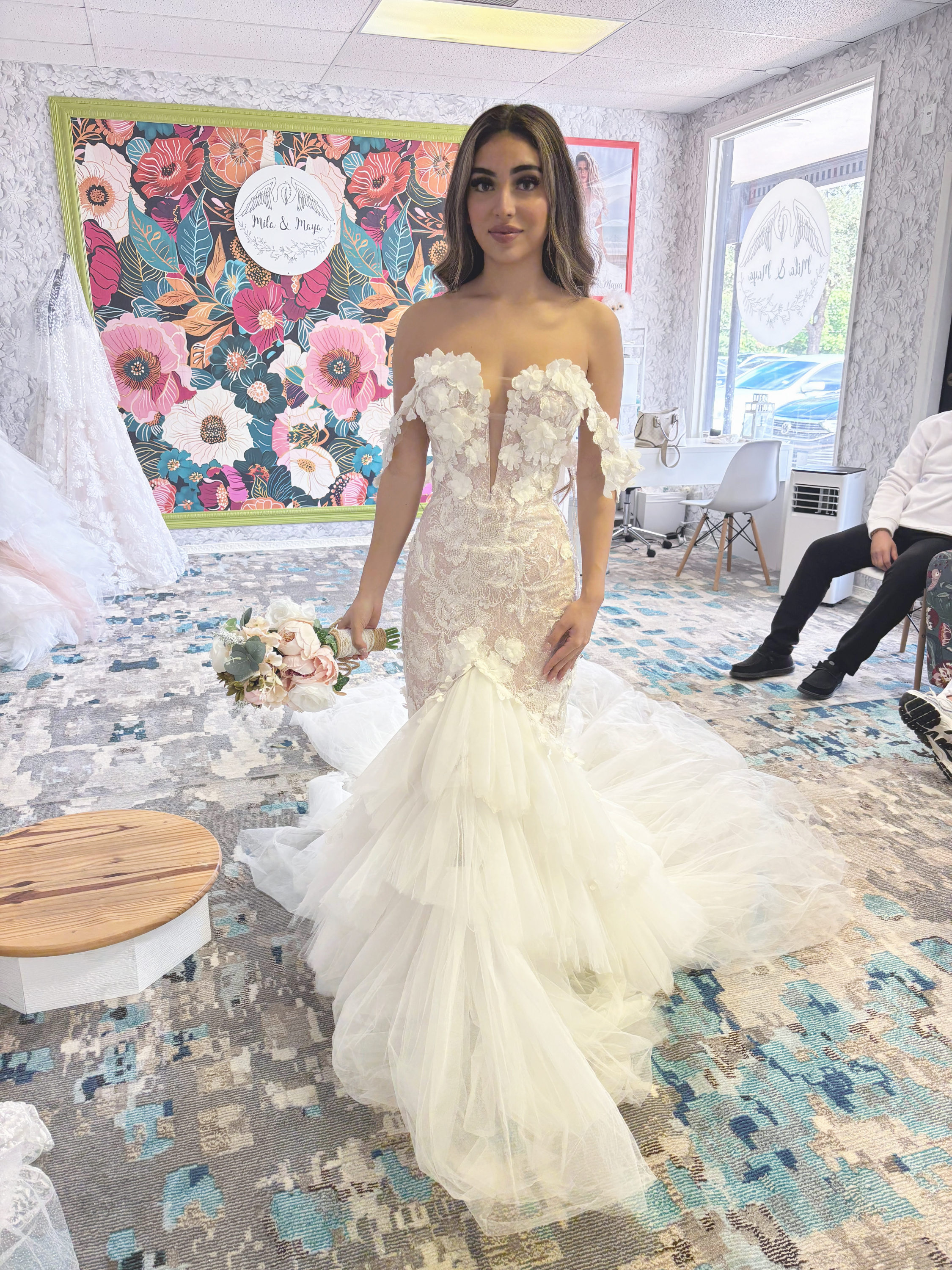 Bride wearing an embellished wedding gown in the bridal boutique