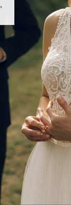 Bride and groom seated outdoors in wedding portrait