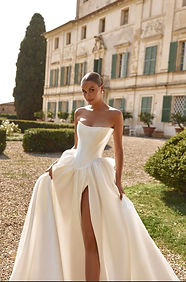 Real bride in an ivory wedding gown outside a historic estate