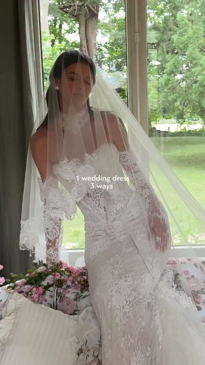 Bride wearing a veil over a lace wedding gown