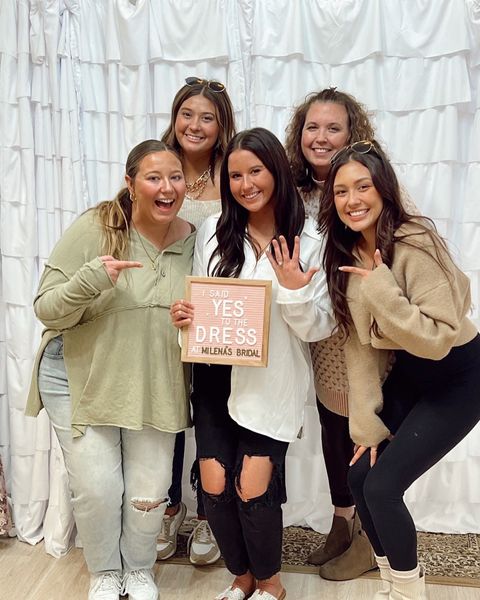 Bride celebrating her dress choice with guests in the boutique