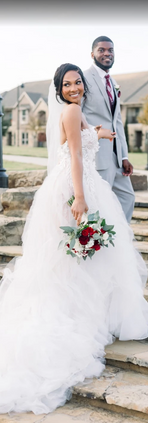 Groom in blue suit holding bride's hand