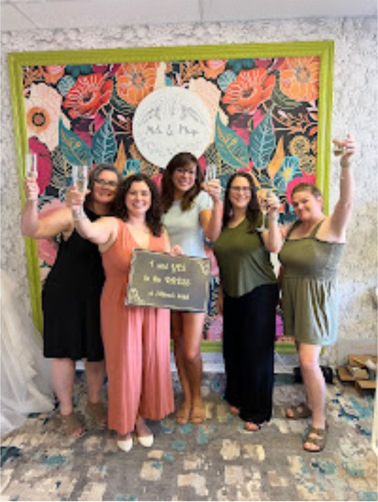 Bride and friends celebrating finding a wedding dress at Milena's Bridal during a private bridal appointment