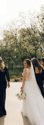 Bride holding bouquet in lace wedding dress
