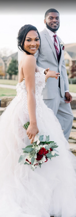 Bride leaning on groom in lace wedding dress
