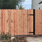 Double redwood gate with exposed black decorative hinges and steel posts. Also has another pedestrian gate in line both having handles to open