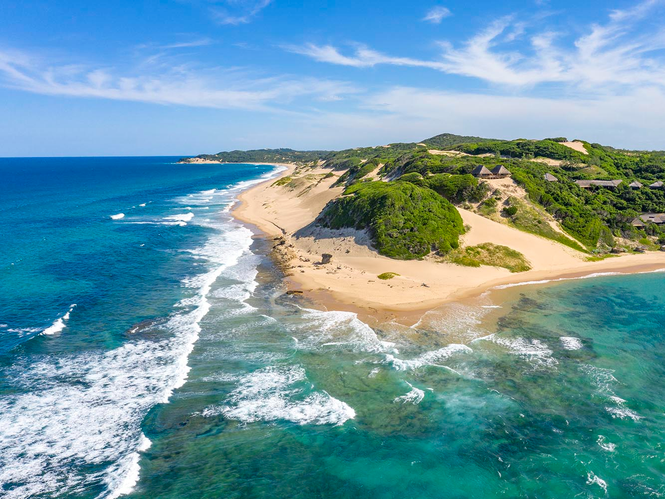 A pristine tropical beach with turquoise water on the coast of Mozambique.