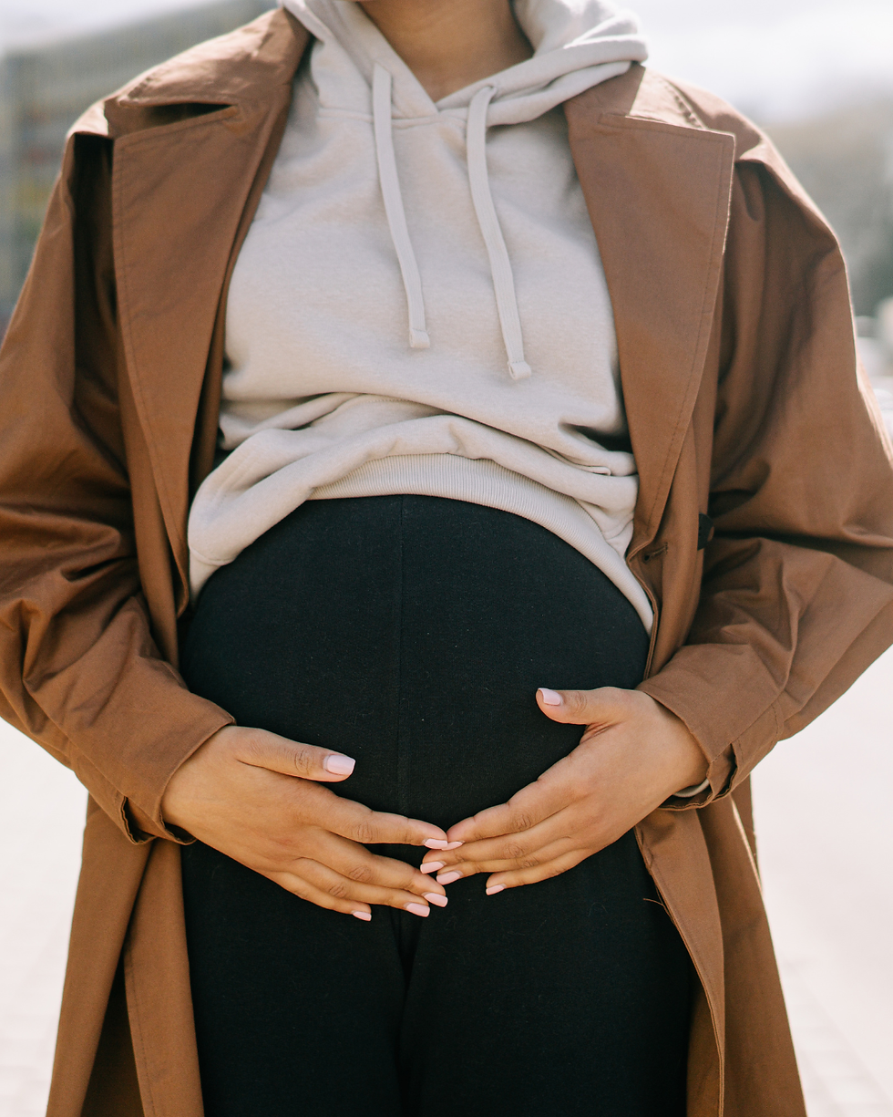 Pregnant woman holding belly