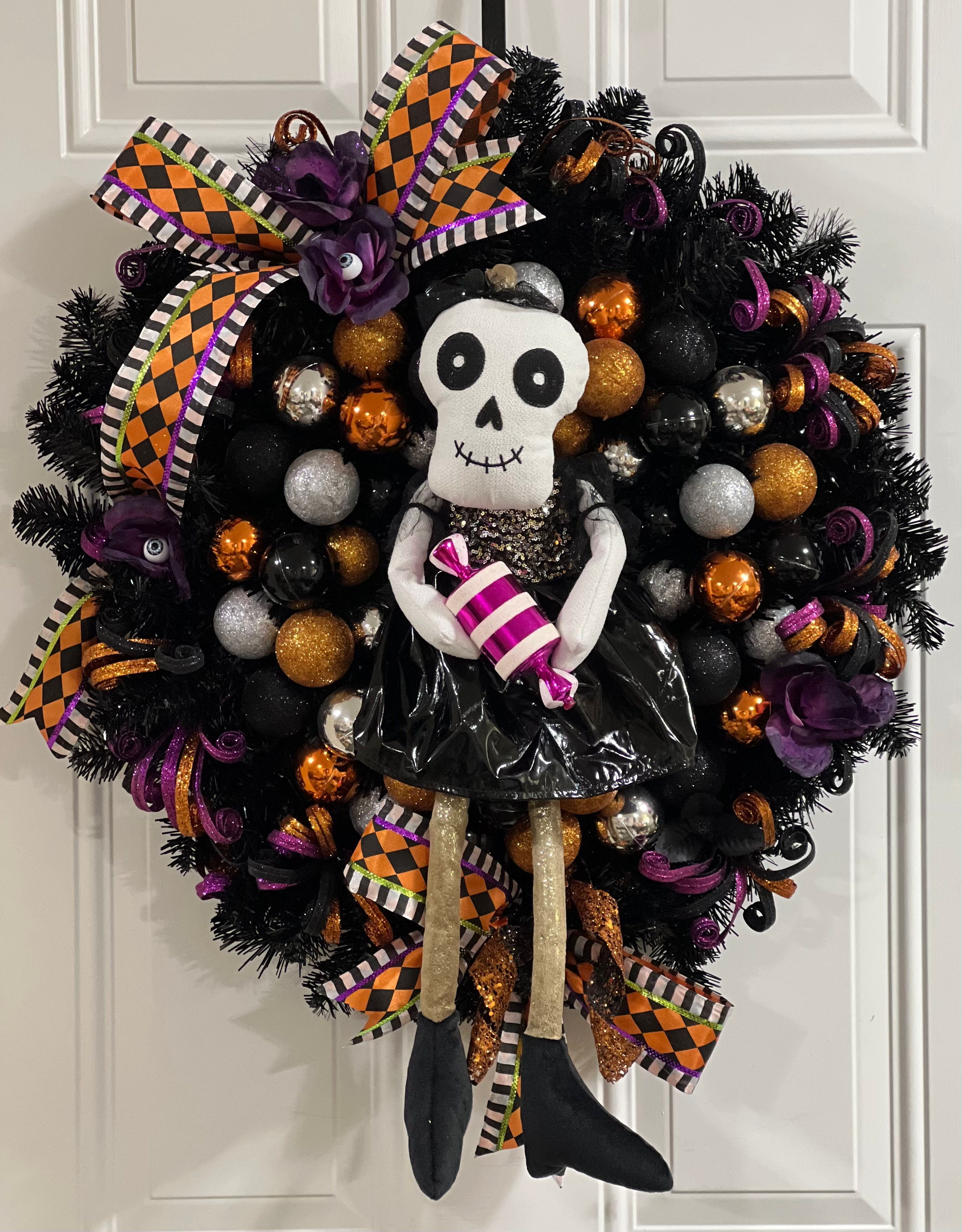 Skeleton Holding Candy Wreath