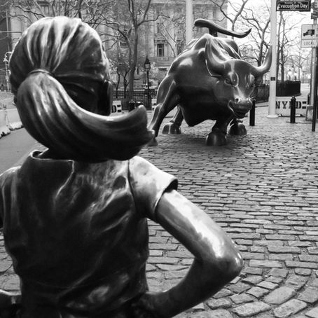 The Fearless Girl statue faces the Wall Street Bull in front of the New York Stock Exchange. Photo by Daniel Lloyd Blunk-Fernández on Unsplash
