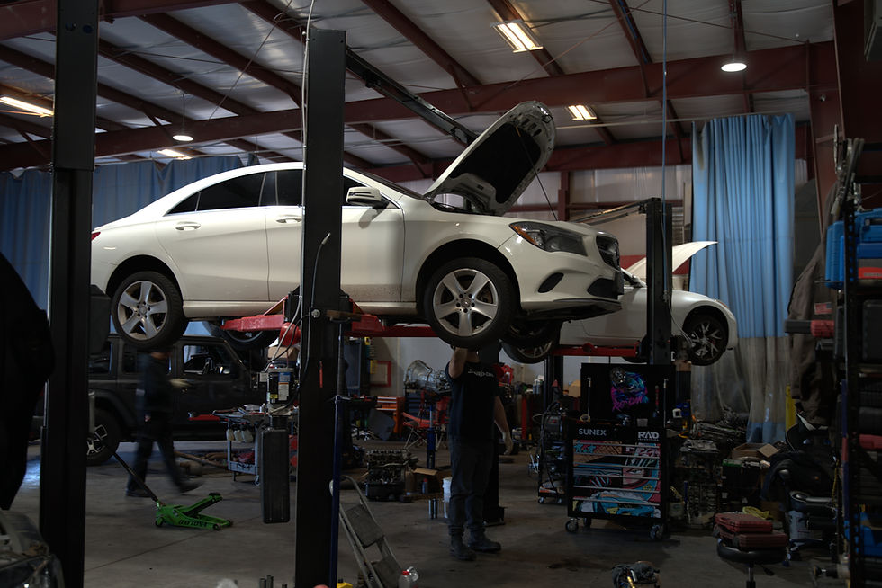 Technicians working on a vehicle inside Envision Performance