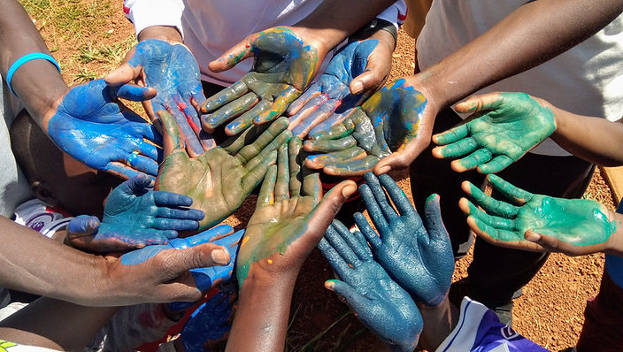 painted hands, landscape, background, space for words, Uganda.jpg