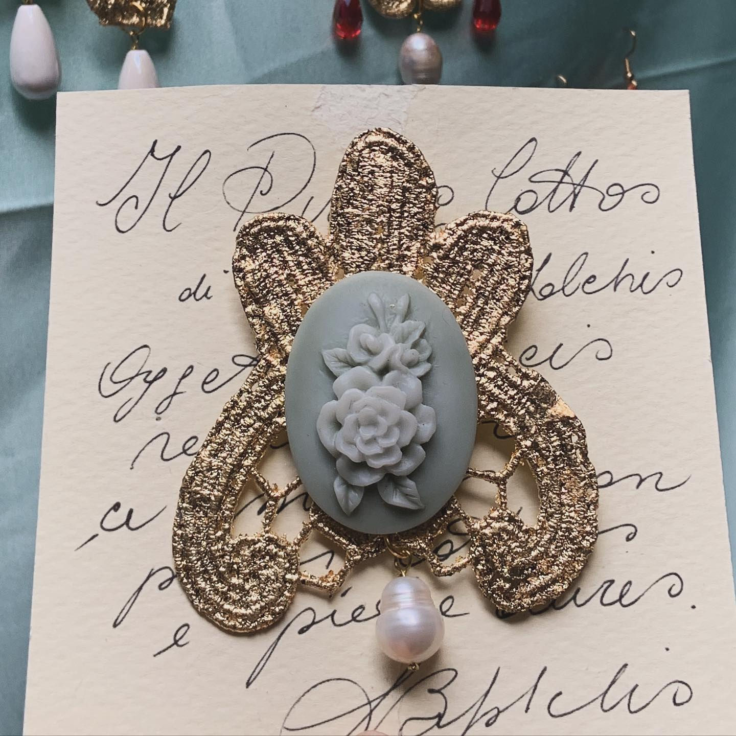 Antique cooked lace brooch with pearl and cameo reproduction.