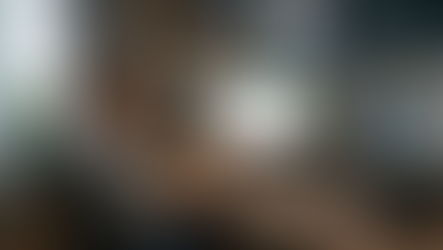 A woman looking at multiple computer screens.