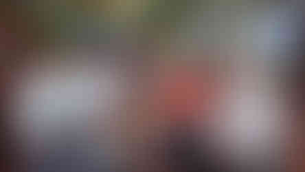 A group of five men posing for the camera inside a bar