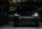 Black Range Rover in a photography portfolio showroom.