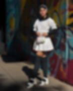 Young woman posing in front of graffiti for a photography portfolio