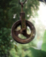 Close-up of a rusty iron pulley in a photography portfolio.