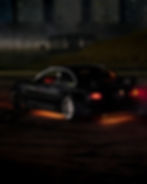 Black car drifting at night in a photography portfolio