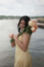 Woman holding roses for a photography portfolio by a lake